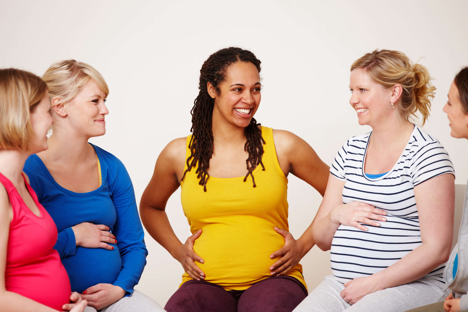 Group of pregnant women sitting together and talking
